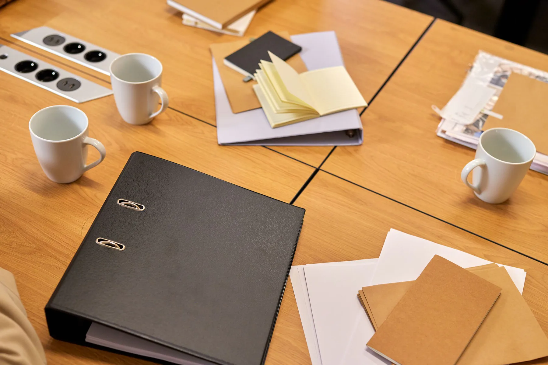 Work files, notebooks and meeting materials arranged on a table